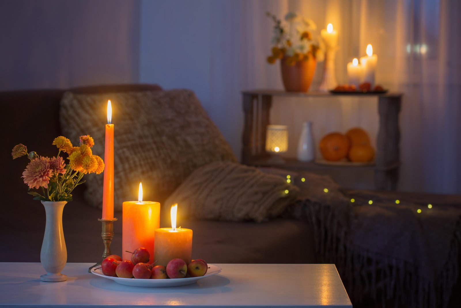 autumn decorations with burning candles at home